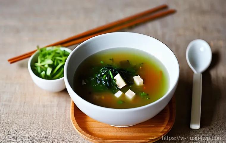 일본식 미소국 기본 레시피 - **Prompt:** A close-up, elevated shot of a chef's hands (a Vietnamese woman in her late 20s to early...